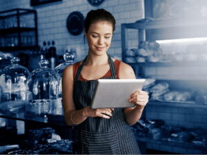 Shot of a young woman using a digital tablet while working in a coffee shop